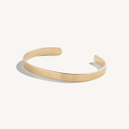 Men’s brushed 18k rose gold open cuff bracelet with rounded edges, on white background.