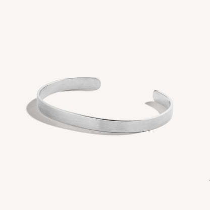 Men’s brushed 18k white gold open cuff bracelet with rounded edges, on white background.