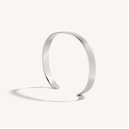 Men’s brushed 18k white gold open cuff bracelet with rounded edges, on white background.