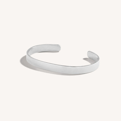 Men’s polished 18k white gold open cuff bracelet with rounded edges, on white background.