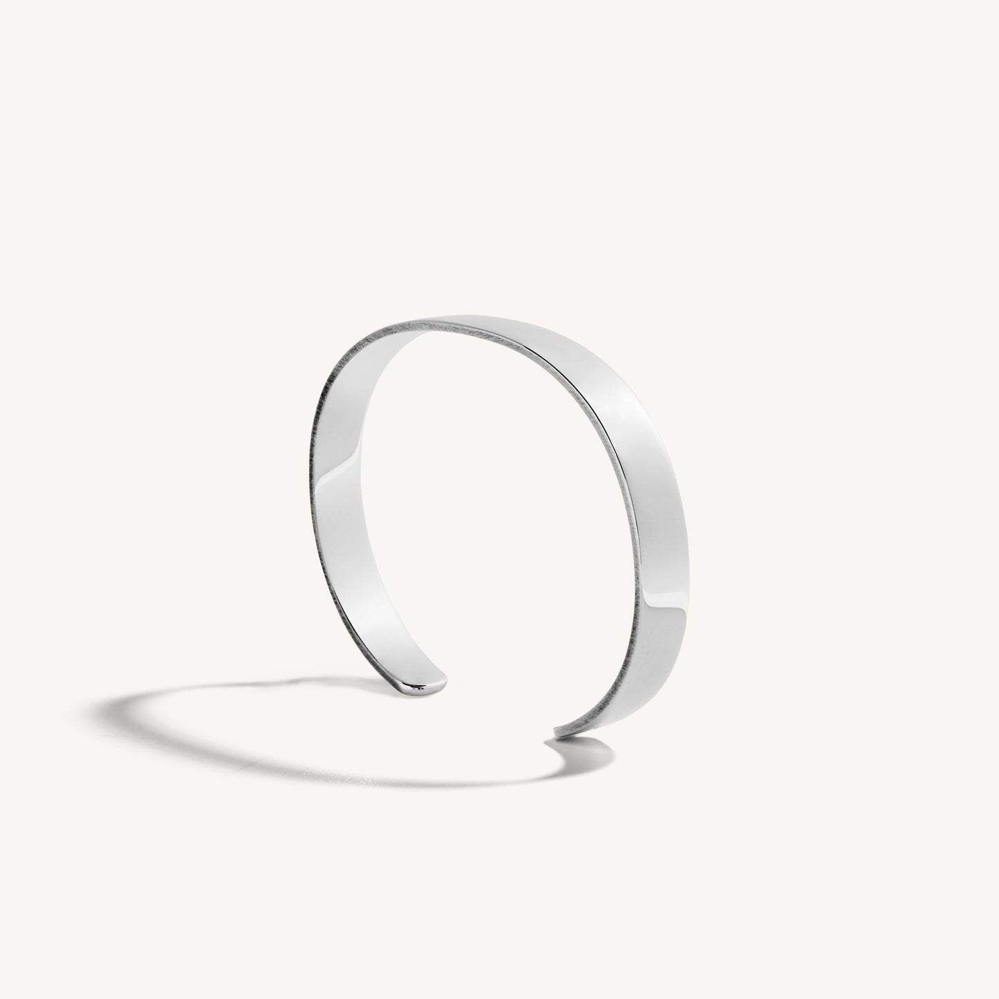 Men’s polished 18k white gold open cuff bracelet with rounded edges, on white background.