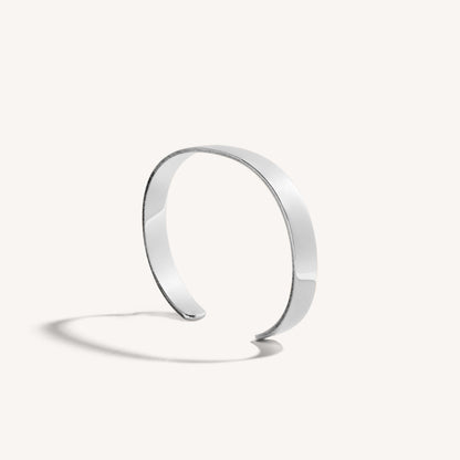 Men’s polished 18k white gold open cuff bracelet with rounded edges, on white background.