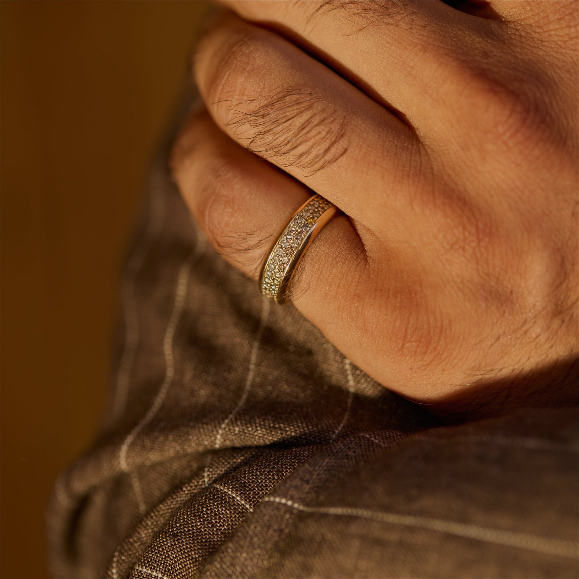 18k rose gold cognac-diamond pavé ring shown on a hand for scale in warm light.
