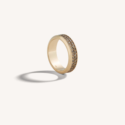 18k rose gold band with channel-set cognac diamond pavé, three-quarter hero on a neutral backdrop.
